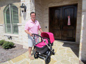 Look at this proud papa. He's never seen anything he loves as much as that cute pink stroller.