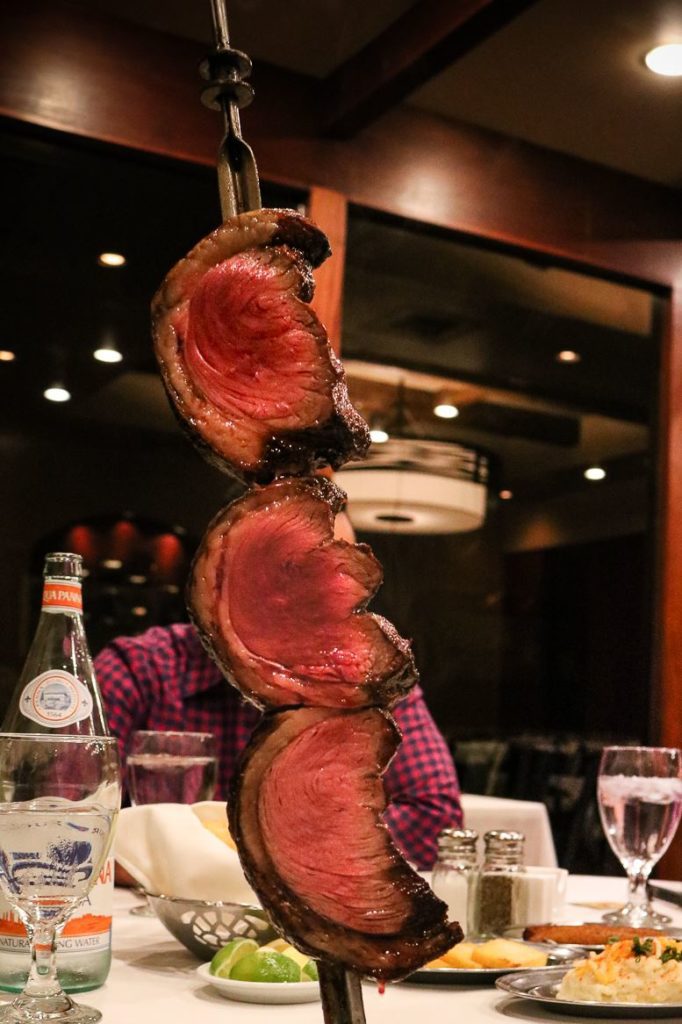 Steak on a sword at Chama Gaucha Brazilian Steakhouse in San Antonio | Alamo City Moms Blog