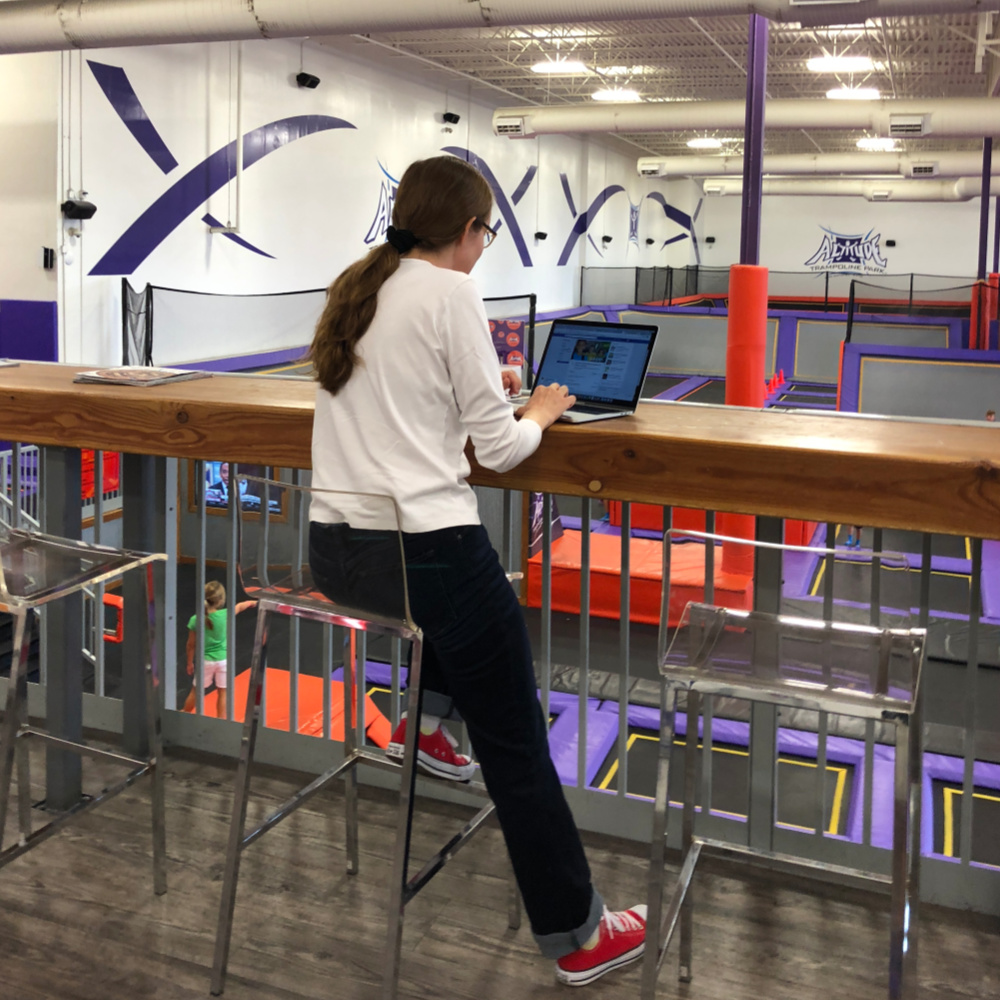 Working mom using the wifi at a trampoline park to get some work done | Alamo City Moms Blog
