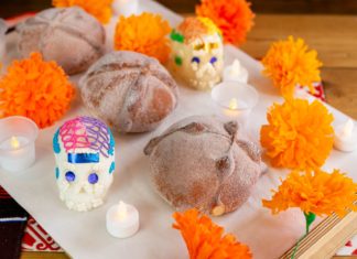 loaves of bread with marigold flowers sugar skulls and candles