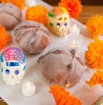 loaves of bread with marigold flowers sugar skulls and candles