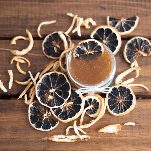dried lemons surrounding a body scrub