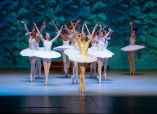 ballet dancers in white tutus on a stage