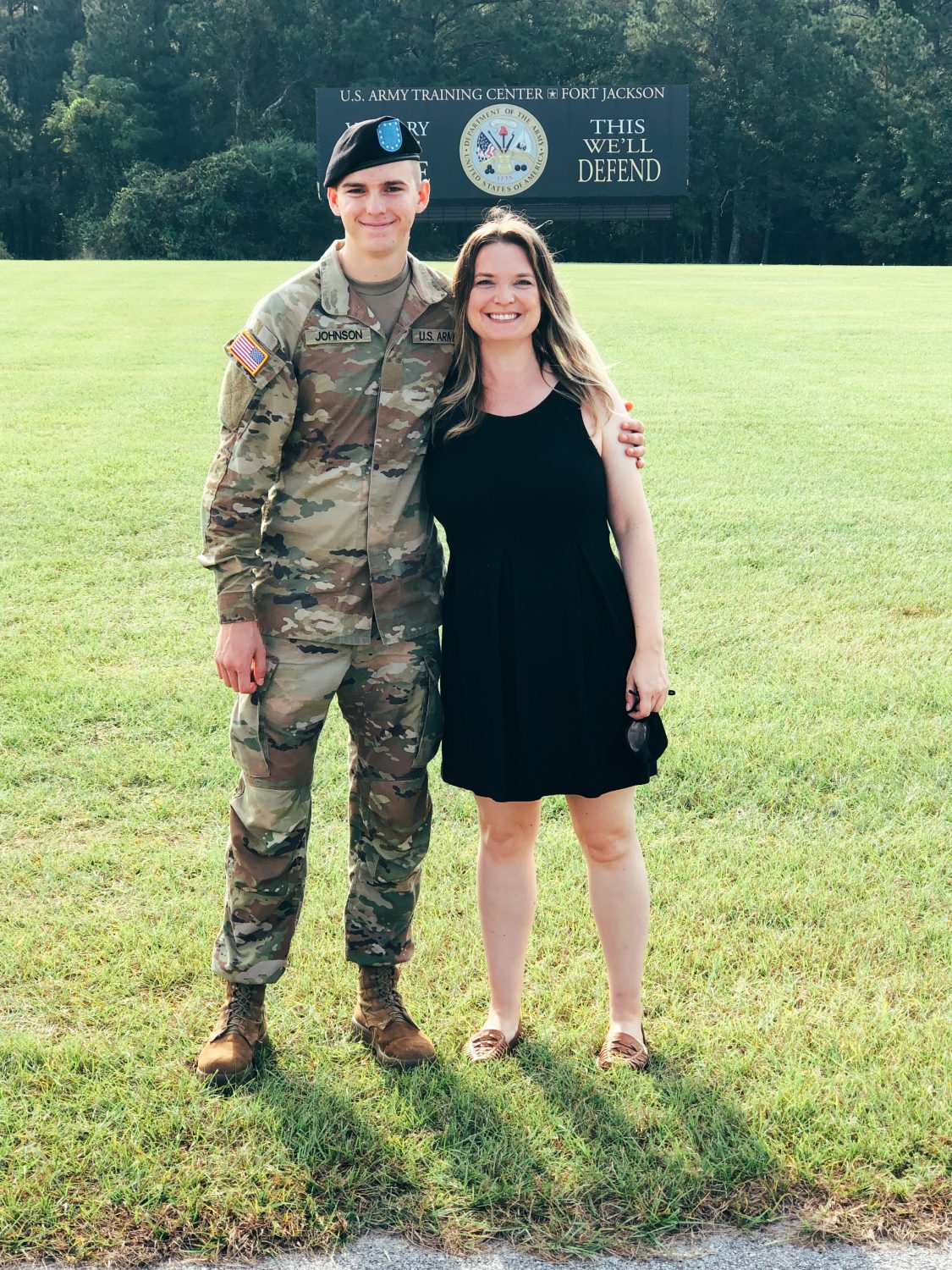 mother standing with son at Army basic training graduation