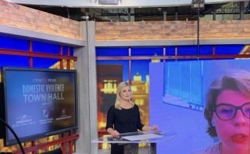a female news anchor reporting in studio
