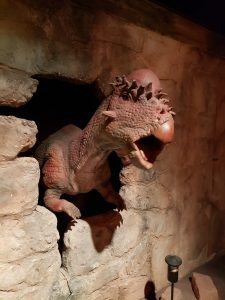 a stygymoloch coming through a wall