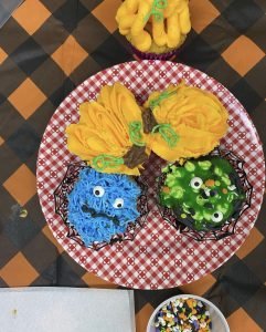 Image of pumpkin and monster decorated cupcakes. 