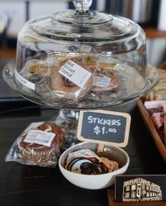 Assortment of bakery treats with labels of different items from donuts to muffins. 