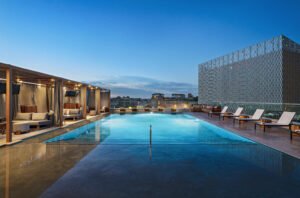 a rooftop hotel pool at twilight 