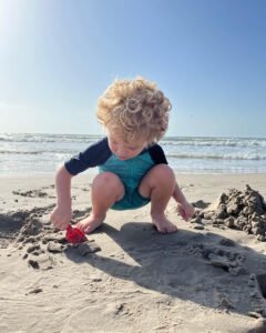 child digging in sand